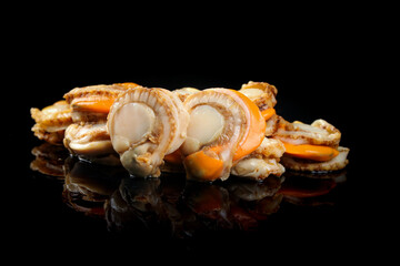 Fresh Raw Qingdao Scallops with Yellowish Flesh on Black Background © KieuThi