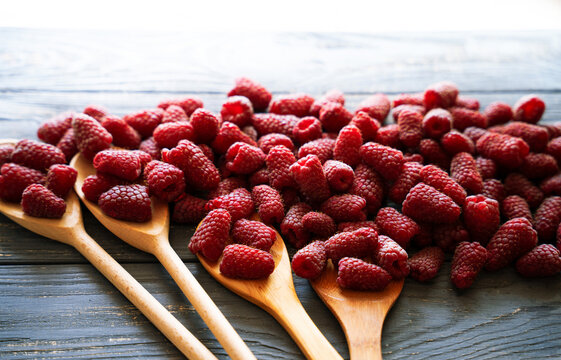 Fresh organic raspberries on wooden table background, food blogging, healthy eating concepts, and seasonal summer harvest themes. Small Farm food	