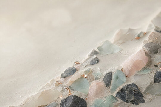 Minimalist concrete texture with embedded raw gemstones, elegant stone surface background, neutral plaster wall with crystal accents