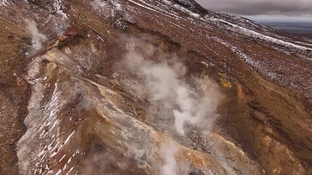 Drone view over steaming volcanic geothermal vent at Ketetahi Hot Springs in New Zealand