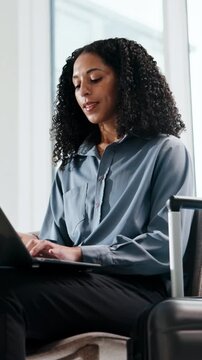 Business, woman or thinking with laptop in airport lounge for flight schedule or online booking. Female person, traveler or planning with suitcase or computer for work trip, travel or job opportunity