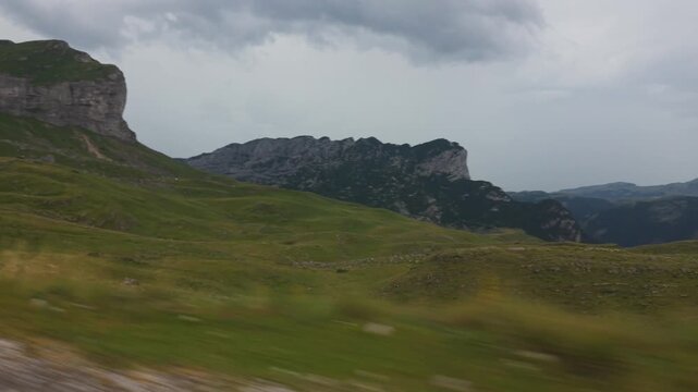 Low angle car side view driving on a scenic mountain road toward Sedlo Pass in Durmitor National Park, Montenegro