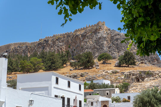 The acropolis on the hill above white houses in Lindos