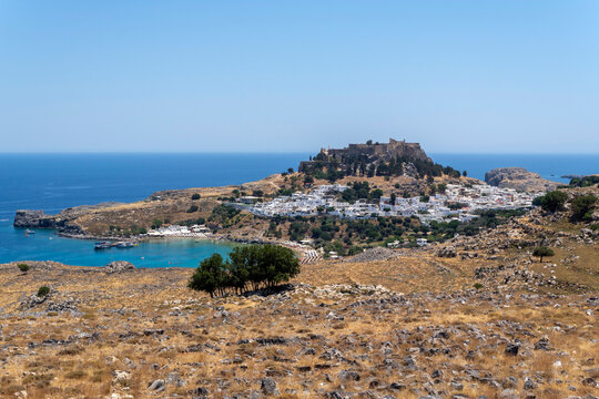 A view of Lindos with the acropolis and the Aegean sea in Greece on a sunny day