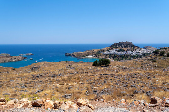 A view of Lindos with the acropolis and the Aegean sea in Greece on a sunny day