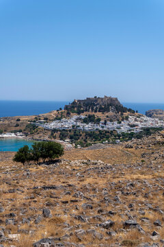 A view of Lindos with the acropolis and the Aegean sea in Greece on a sunny day