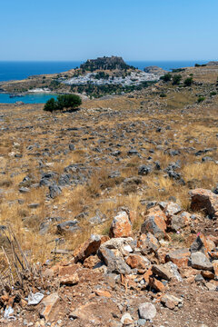 A view of Lindos with the acropolis and the Aegean sea in Greece on a sunny day