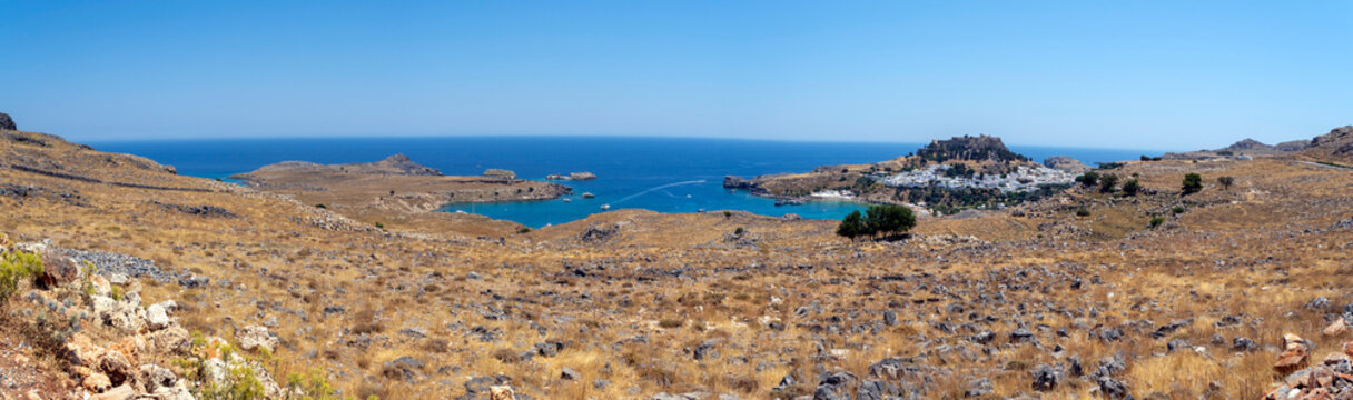 Panoramic view of Lindos with the acropolis and the Aegean sea in Greece on a sunny day