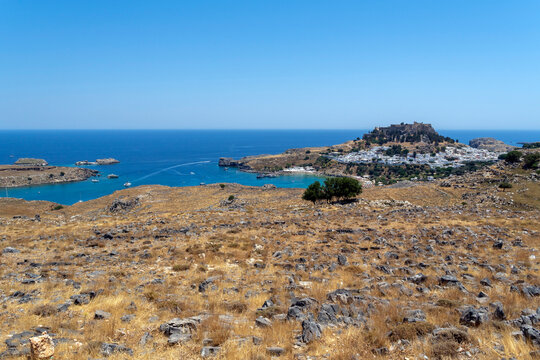 A view of Lindos with the acropolis and the Aegean sea in Greece on a sunny day