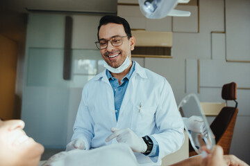 Dentist explaining procedure to patient during dental checkup