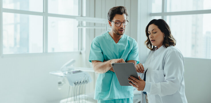 Discussion between dental colleagues continues with tablet review in the clinic