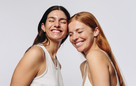 Women laughing and leaning together