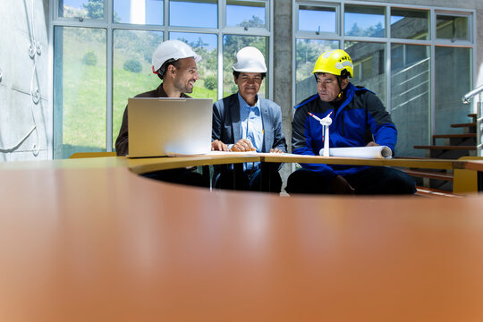 Team of engineers planning wind farm project in modern office