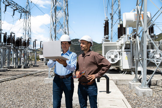Engineers use a laptop at a substation in Loja Ecuador
