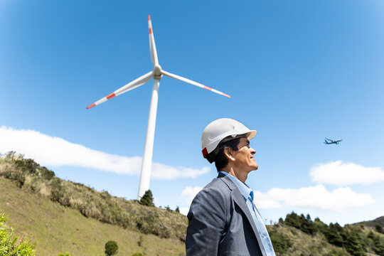 Male engineer observes wind turbine in Loja Ecuador