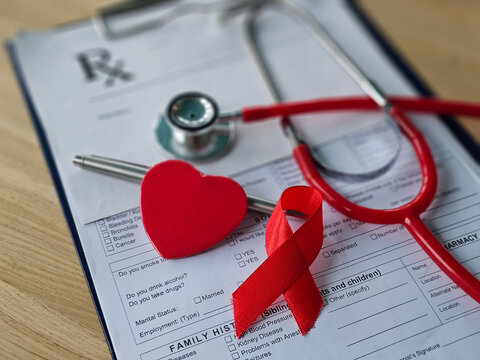 Health care items on a medical form with a stethoscope, a red ribbon, and a heart symbol concept