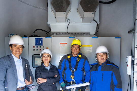 Professional coworkers inspect a wind turbine base indoors