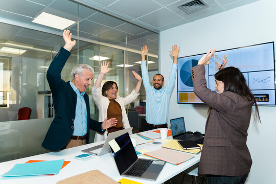 Business team celebrates success in the office meeting room