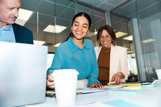 Business colleagues analyze documents during a meeting at the office