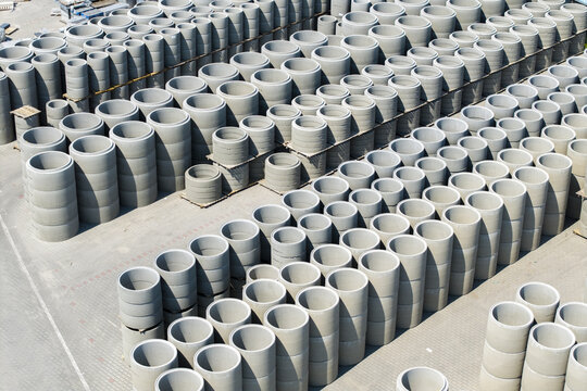 Aerial view of stacks of concrete pipes and precast elements at the Bruk-Bet industrial yard in Poland.