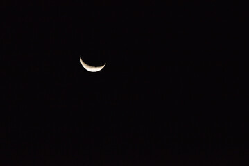 A crescent moon above the Great Wall at Laolongtou during twilight in Shanhaiguan, Hebei Province, China. © Isabel