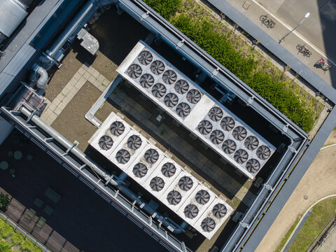 Aerial view of ai data center rooftop featuring rows of industrial cooling fans and ventilation systems on a modern building in Krakow, Lesser Poland Voivode, Poland.