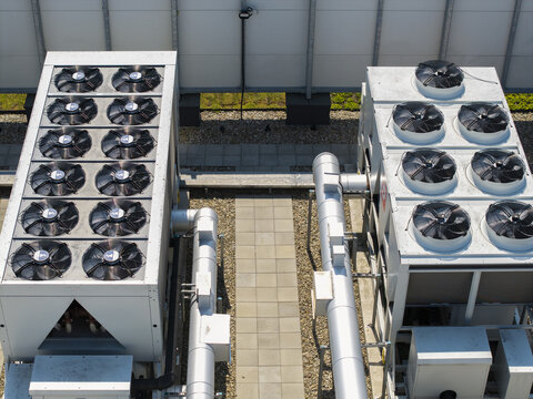 Aerial view of industrial cooling units for an ai data center with large fans and metal pipes on a rooftop in Krakow, Lesser Poland Voivode, Poland.
