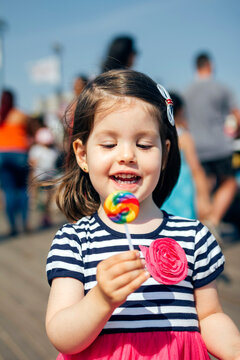 USA, New York, Coney Island, happy little girl with lollipop