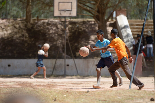 Madagascar, Fianarantsoa, Boy playing soccer in school yard