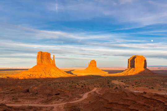 USA, Colorado Plateau, Utah, Arizona, Navajo Nation Reservation, Monument Valley, West Mitten Butte, East Mitten Butte and Merrick Butte in sunlight