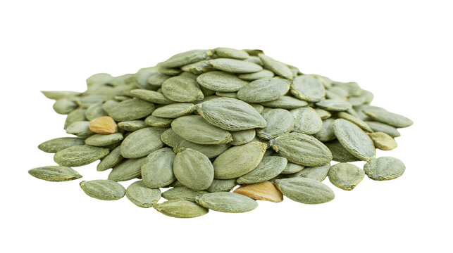 Pile of green pumpkin seeds pepitas, with one tan seed visible