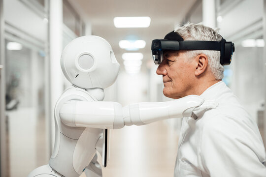 Medical professional uses augmented reality headset with robot in laboratory