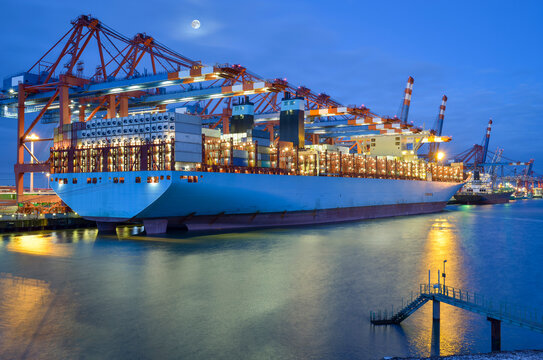Germany, Hamburg, container ship at terminal in the morning