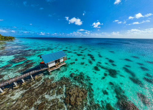 Aerial view of boat shed on turquoise lagoon in Fakarava French Polynesia