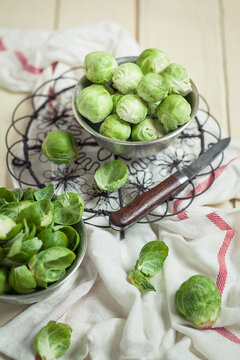 Peeled brussel sprouts in tin bucket, knife, studio