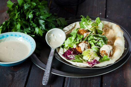 Homemade falafel with salad, tahini sauce on flat bread