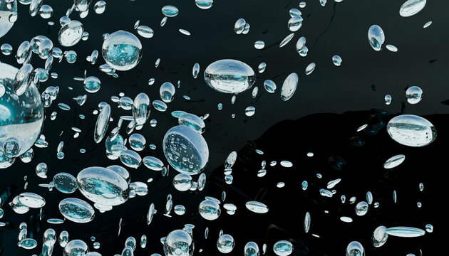 Abstract transparent bubbles floating against a black background