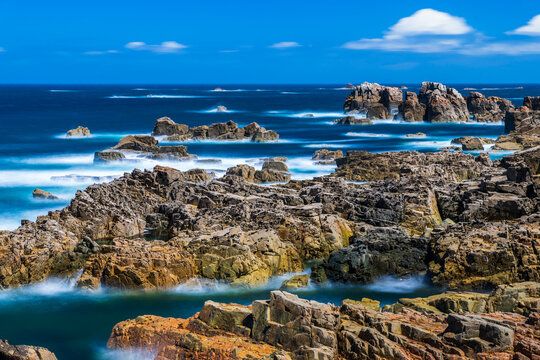Ocean waves crash against the rocky coastline in Brittany