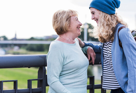 Happy grandmother and granddaughter face to face