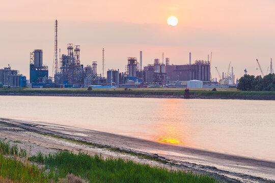 Belgium, Flanders, Antwerp, Scheidt river, industrial area, oil refinery at sunset
