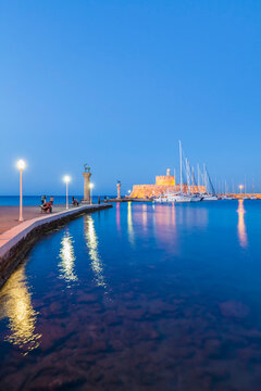 Greece, Rhodes, entrance to Mandraki harbour at blue hour