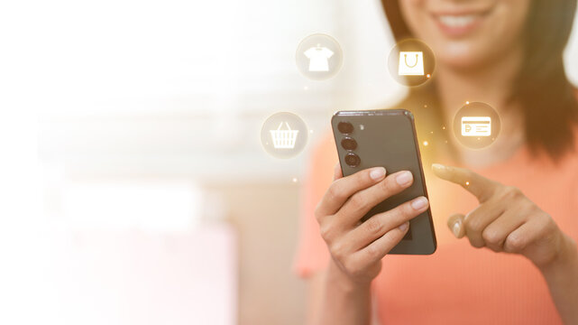 Asian woman using smartphone for online shopping and mobile payment