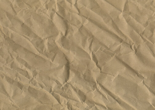 Packing crumpled paper texture. Brown craft paper texture for design. Vintage paper antique texture.	