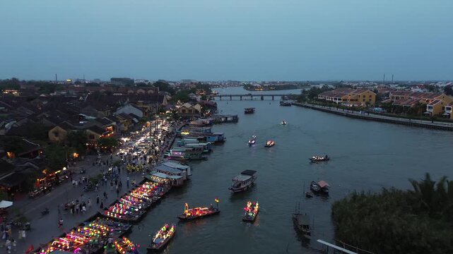 Aerial view of the thu bon river with traditional boats and lanterns in hoi an, vietnam
