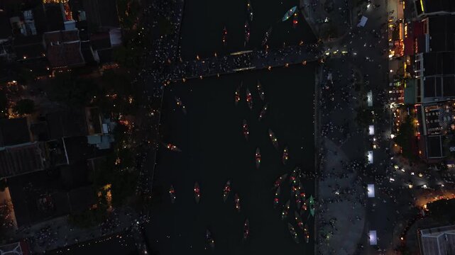 Aerial top-down view of boats with lanterns floating on the thu bon river in hoi an at night