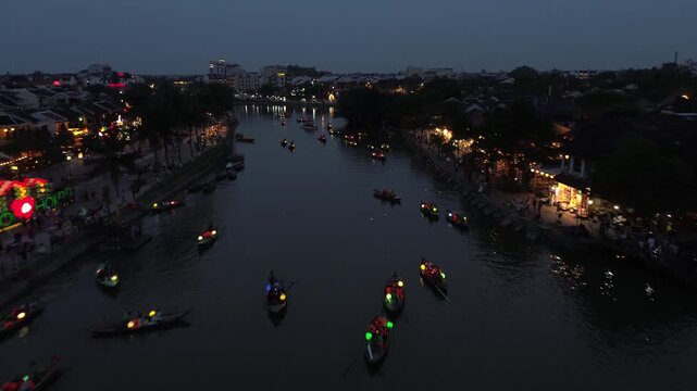 Traditional boats with colorful lanterns floating on the thu bon river in hoi an, vietnam at night