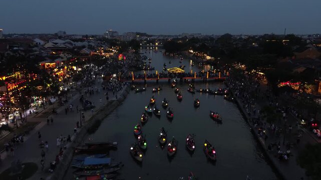 Romantic boats carrying tourists with colorful lanterns sailing on the thu bon river at night