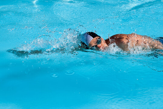 Scene featuring athletic Man swimming in the pool