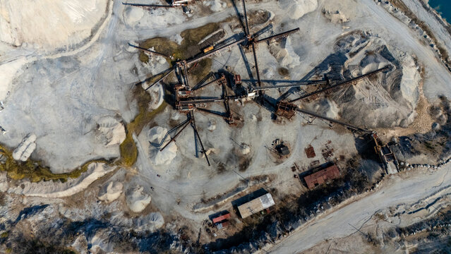 Aerial view of the Tompkins Cove Quarry featuring industrial conveyor belts, gravel piles, and mining equipment in a rugged landscape in Stony Point, New York, United States.