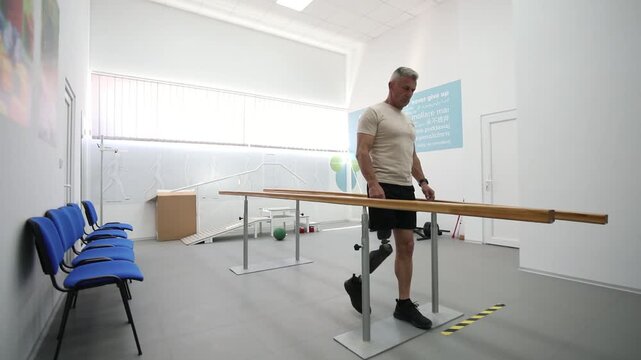 An amputee test his prosthesis during a prosthetic fitting session in hospital